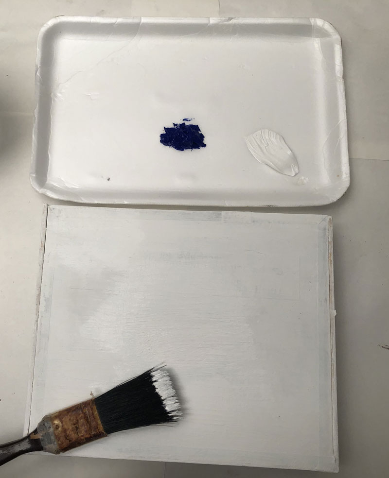 Box painted white with a paint brush