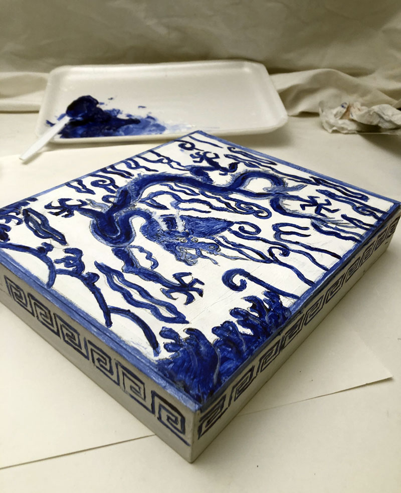 Blue design of a dragon with geometric patterns on the sides
