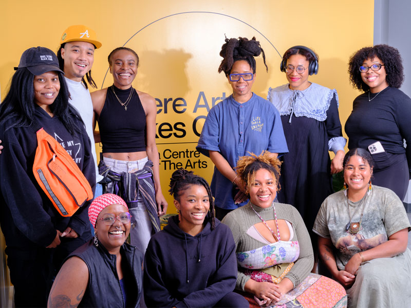 A group of young Black artists from Nia Centre for the Arts posing in a group