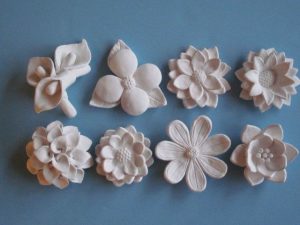 White ceramic flowers on a blue background
