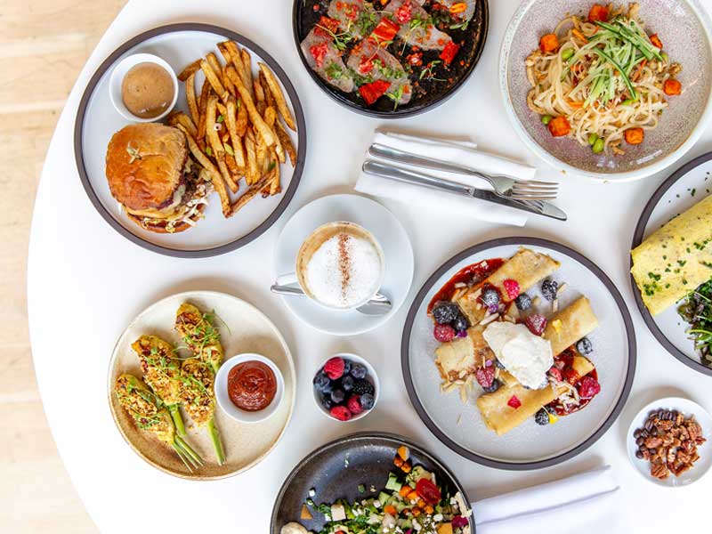 Clay-Restaurant-Thumbnail Plates of food on a table seen from overhead