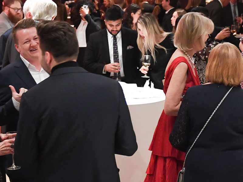 A crowd of people in formal dress at an event