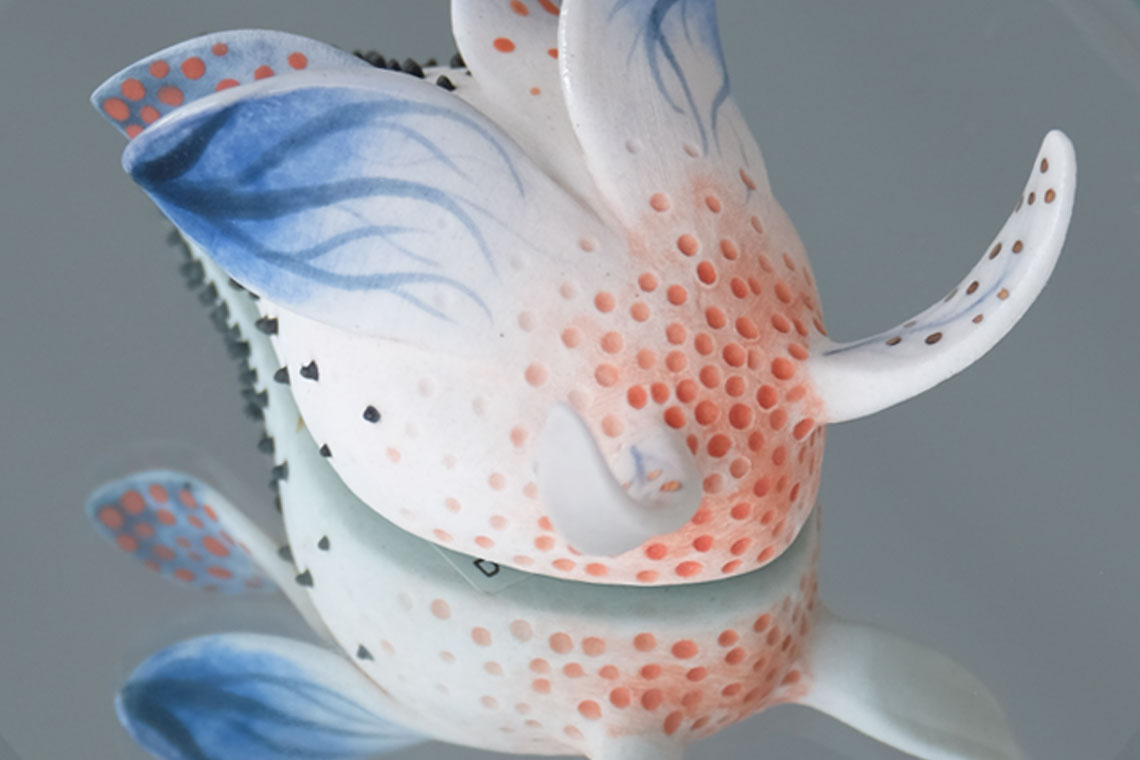 Ceramic beetle on a mirrored dish
