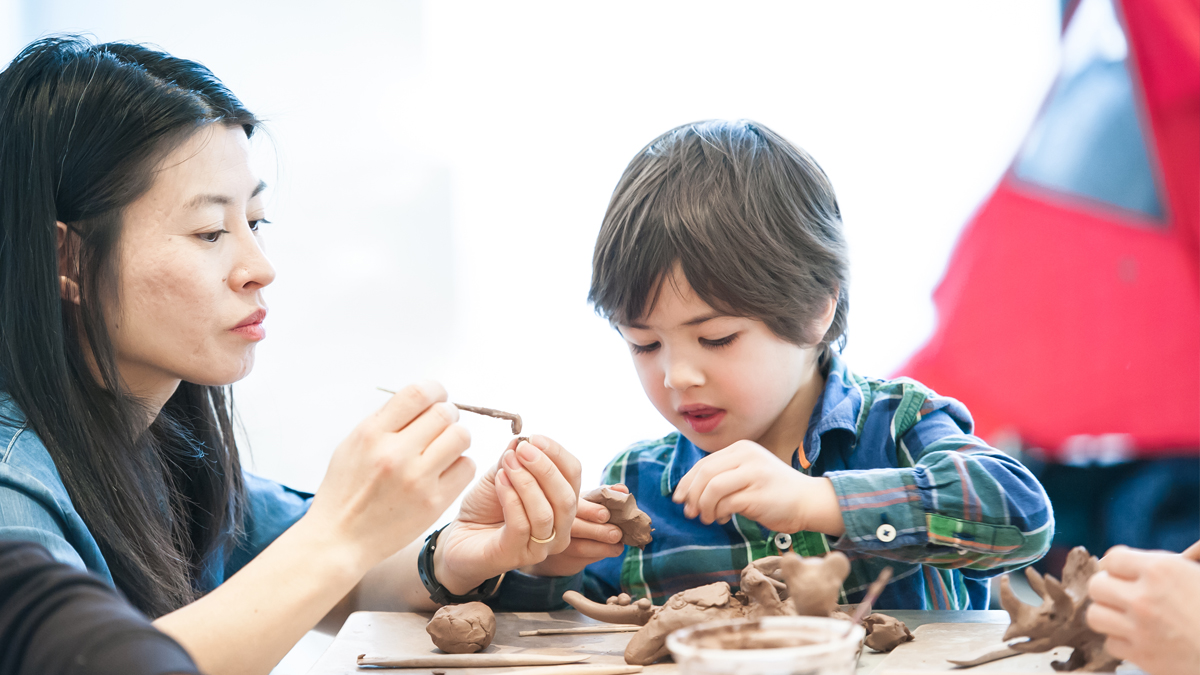 Mother and son working on a clay project
