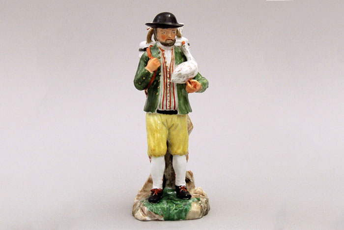 Porcelain figure of a farmer holding a goose