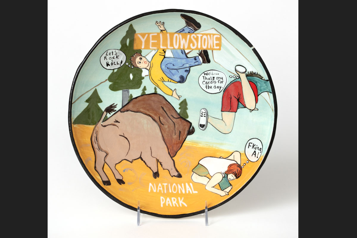 A plate with a scene of tourists being thrown in the air by a buffalo