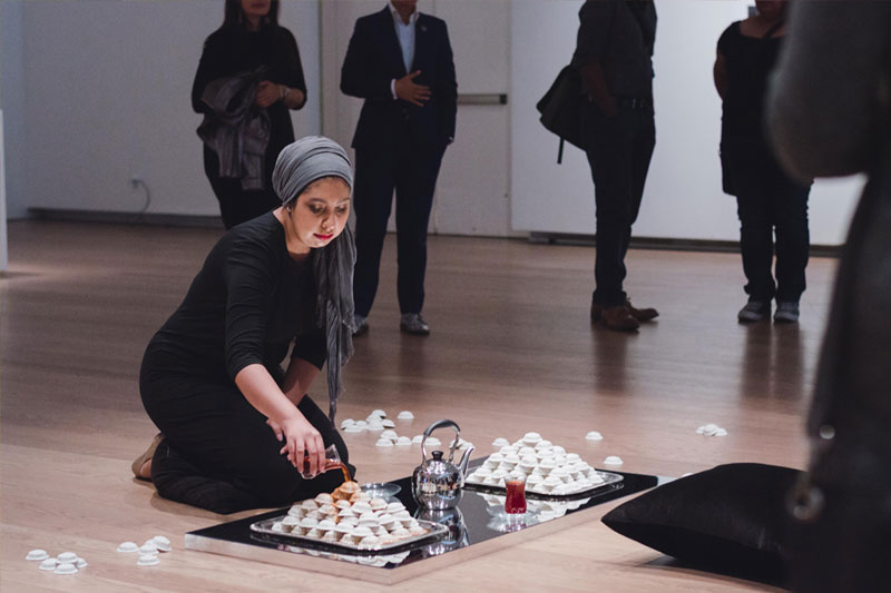 Habiba El-Sayed pouring tea over clay biscuits