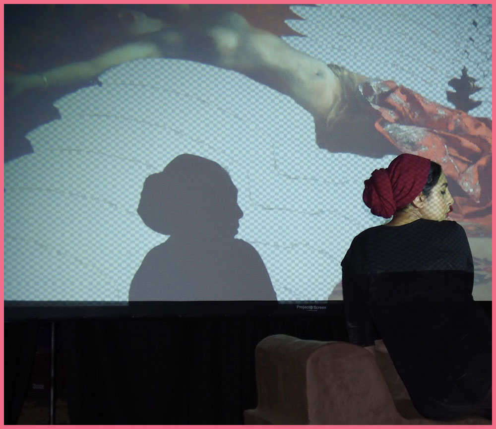 Artist Habiba El-Sayed in profile in front of a screen