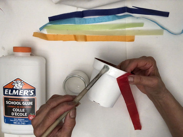 Gluing tissue paper onto a white pot