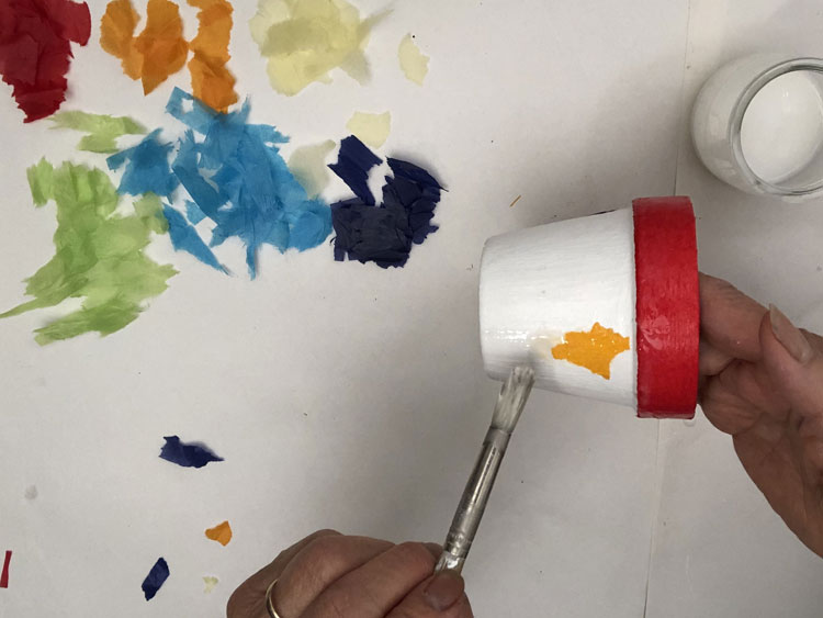 Gluing tissue paper onto a white pot