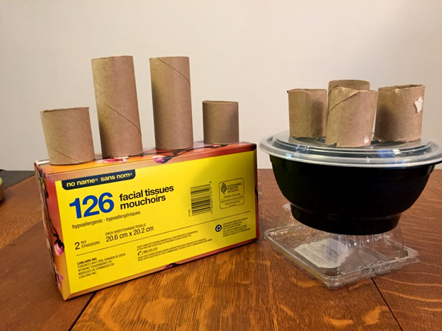 Toilet paper rolls of different lengths stuck to a tissue box and take out soup container