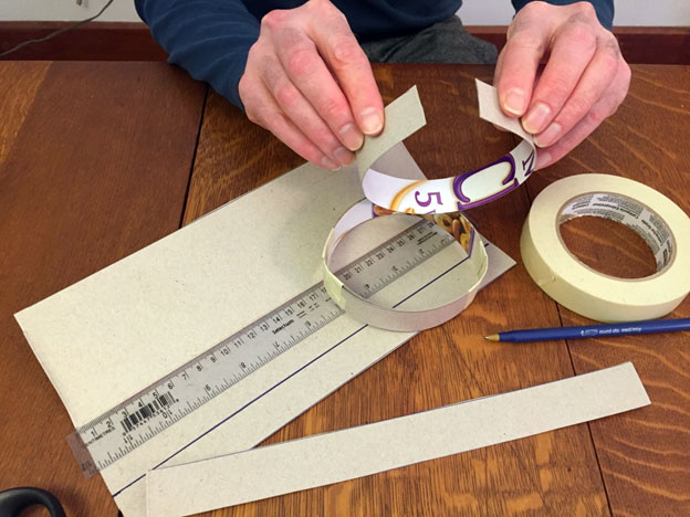 Hand shaping a cardboard ring