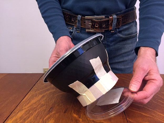 Taping a plastic lid underneath a take out container