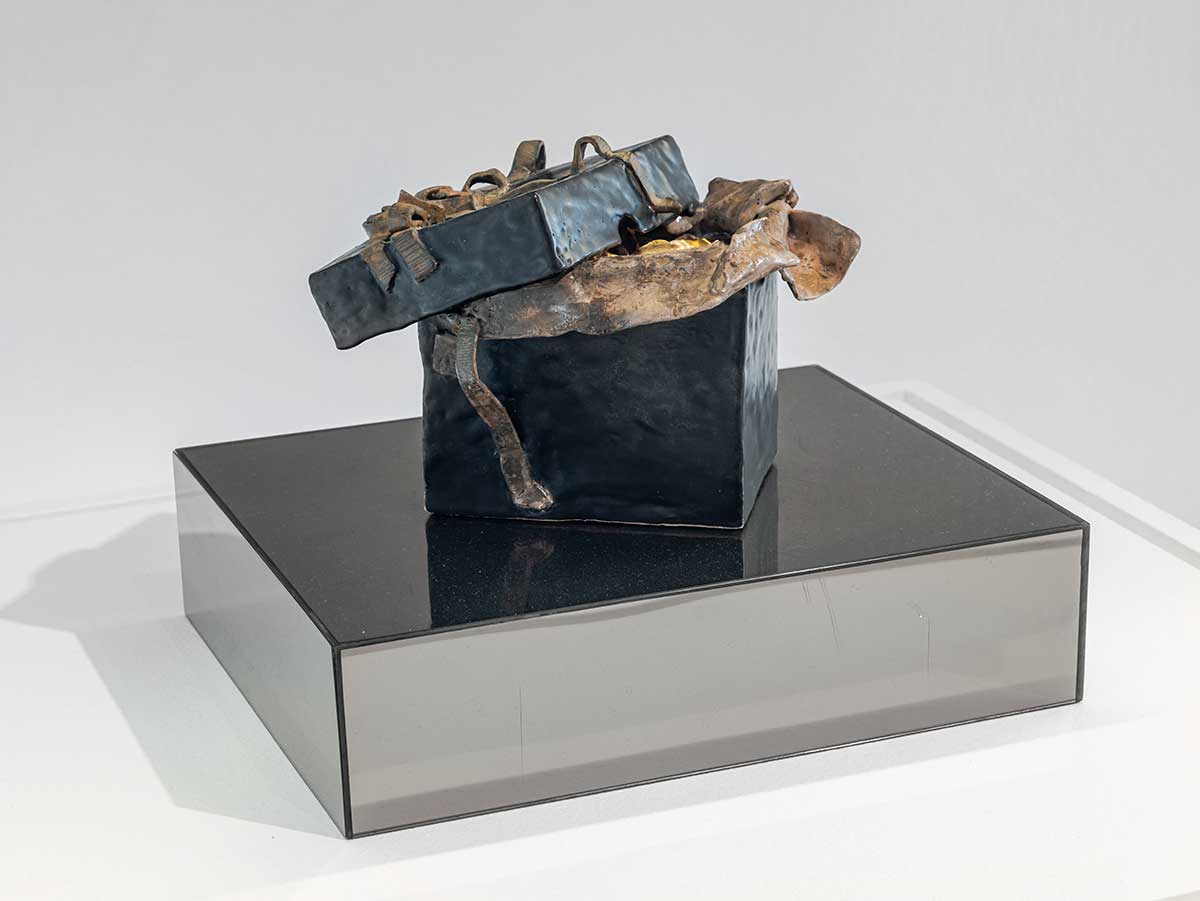 A ceramic sculpture of a gift box