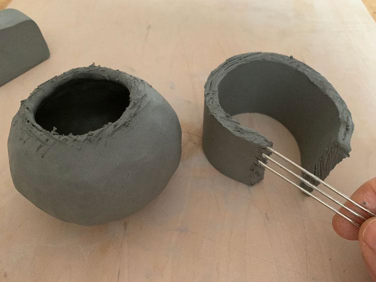 Scraping the neck of a clay pot