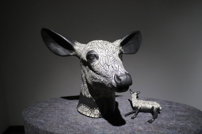 Large deer head and small deer decorated with sgraffito