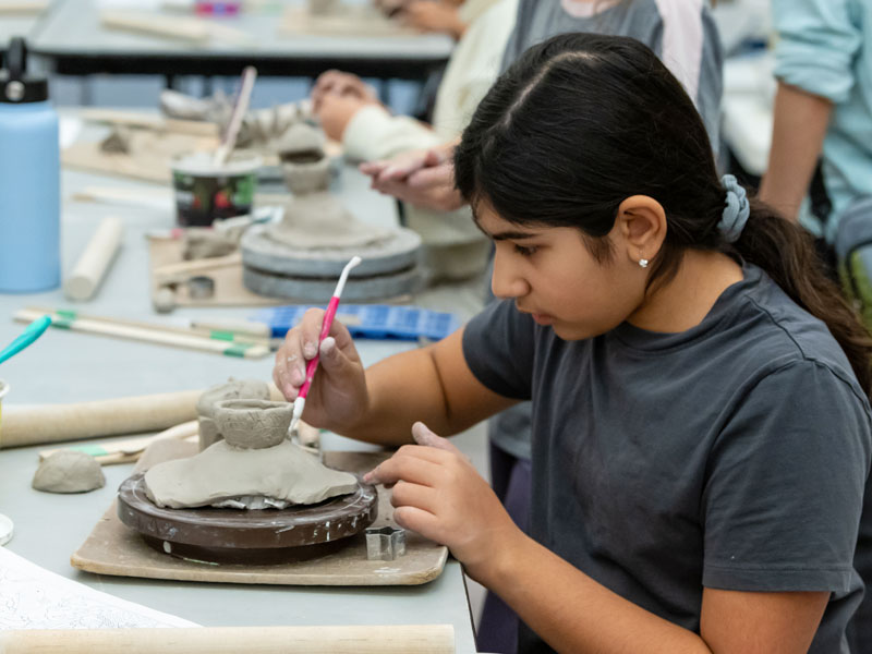 Kids-Class-Thumbnail-Spring-2025 A young girl with working with clay in the studio
