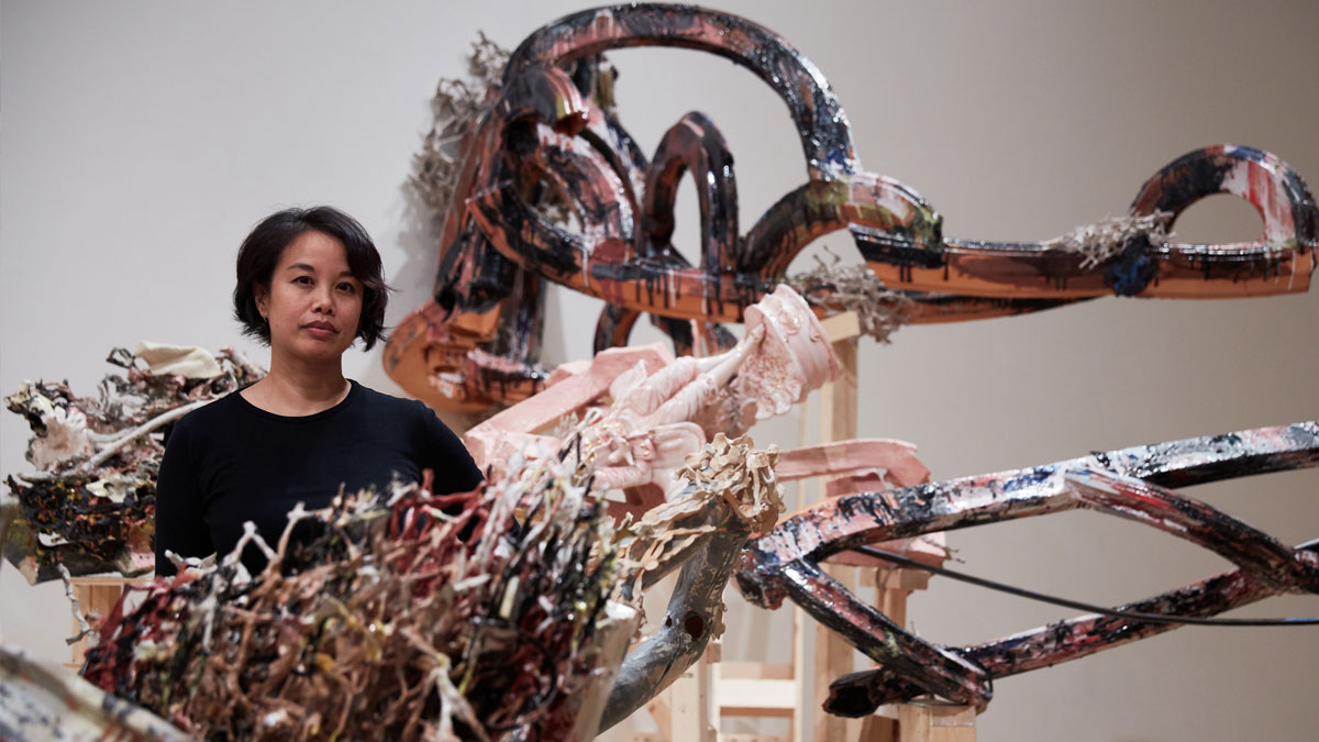 Artist Linda Sormin surrounded by a ceramic and wood installation