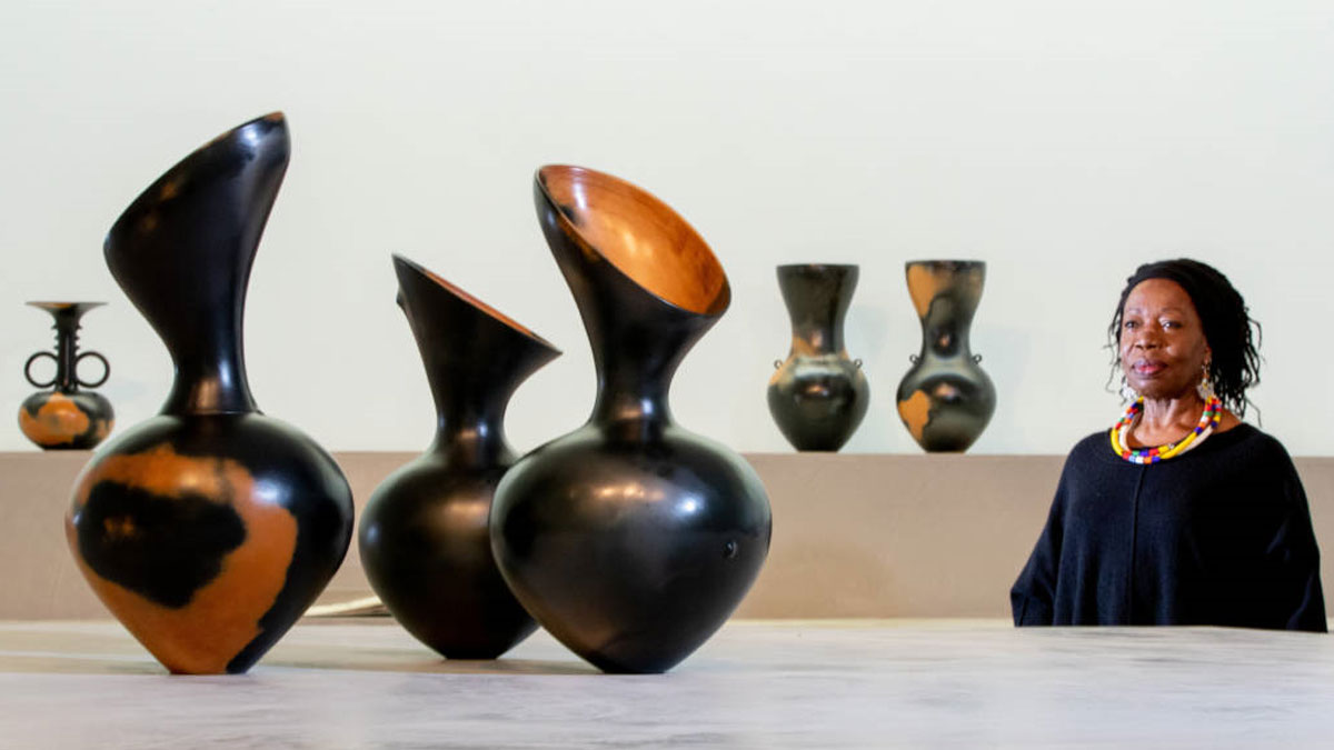 Artist Magdalene Odundo with her ceramic vessels