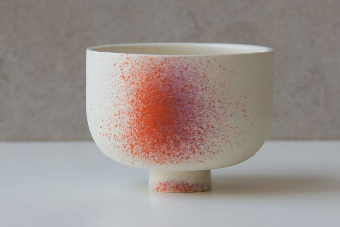 White ceramic cup with orange and purple spatter paint