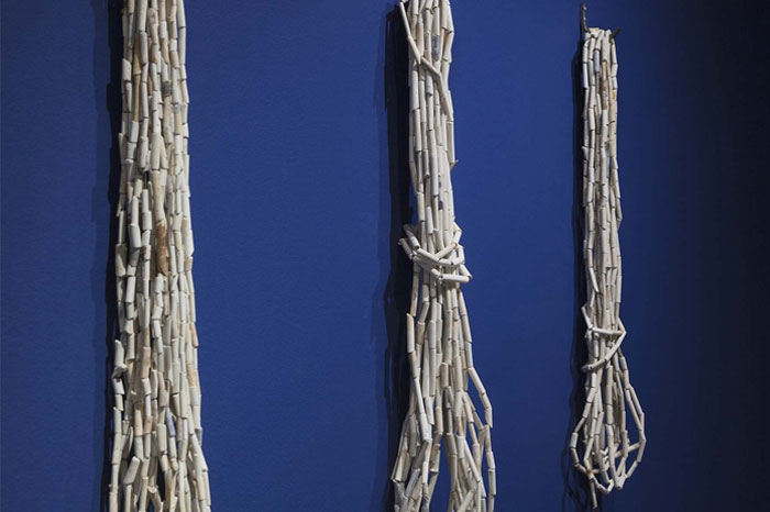 Hanging bundles of clay pipe stems strung together