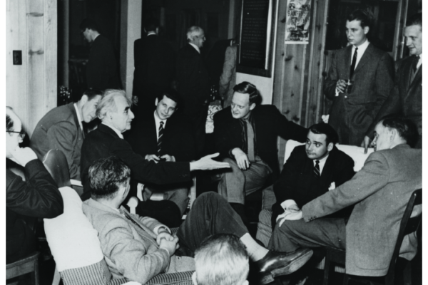 Richard Neutra (hand extended) in conversation after a lecture at the Vancouver Art Gallery, with Arthur Erickson (centre) and Ron Thom (centre right), 1949. Photographer unknown. Collection of the Thom family.