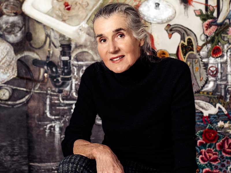Artist Natalka Husar wearing a black turtleneck and leaning her arm on her leg