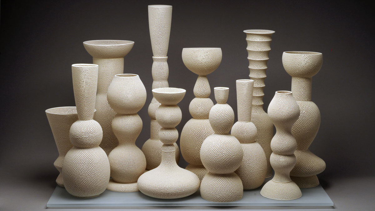 Grouping of perforated white ceramic vessels